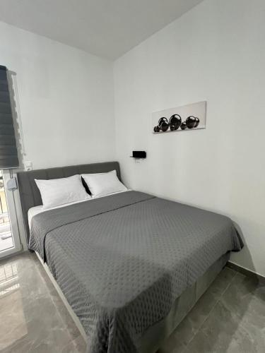 a bedroom with a bed with two clocks on the wall at Drama Homes Argiroudi in Drama