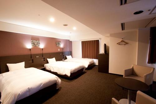 A bed or beds in a room at Smile Hotel Kyoto Shijo