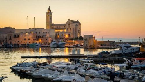 a group of boats docked in a marina at sunset at Riflessi nosTrani - Seaside Rooms in Trani