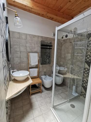 a bathroom with two sinks and a glass shower at Santanna106 in Santa Domenica