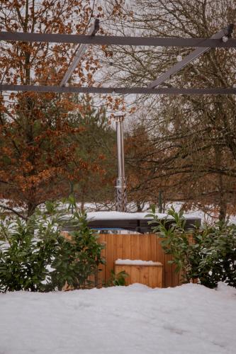 a fence in the snow with a train at Zen Sasino in Sasino