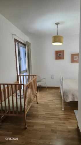 a bedroom with a bed and a wooden floor at La Quinta Adosado in Santa Úrsula
