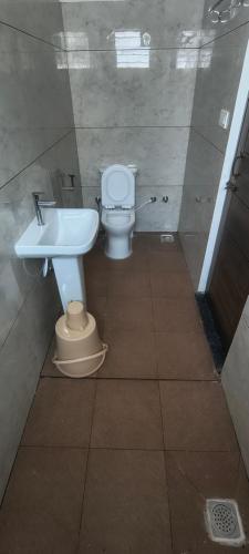a bathroom with a toilet and a sink at Sky Light Mysore in Mysore South