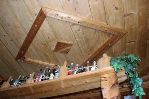 a bunch of bottles on a shelf in a room at Hotel Villa Rina in Bormio