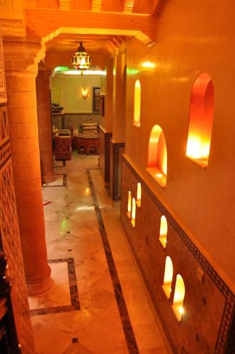a hallway with lights on the wall of a building at Essaouira Wind Palace in Essaouira