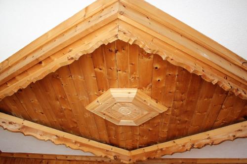 a ceiling of a wooden building with aventricular at Hotel Villa Rina in Bormio