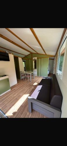 a living room with a couch and a table at Chalet en Corse in Santa-Maria-Figaniella