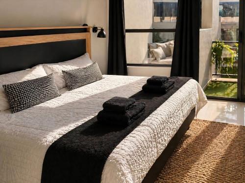 a bedroom with a bed with two towels on it at Beach, Restaurants, Shopping, Park, Pier - nearby in Durban