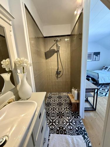 a bathroom with a shower and a sink at SwedenWoods in Hagfors