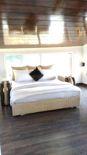 a bedroom with a large bed in a house at Luxury Chalet Villa in Shimla