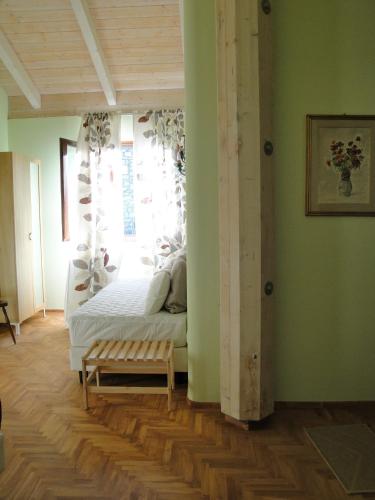 a bedroom with a bed with a window and a bench at Taverna Centomani in Potenza