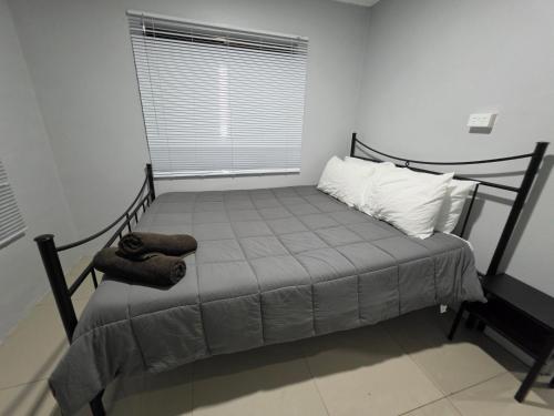 a small bed in a room with a window at BOU's Accomodation in Nadi