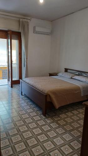 a bedroom with a large bed in a room at Casa Carmela in Sapri