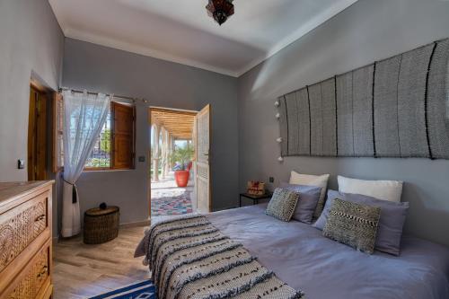a bedroom with a bed with a large headboard at Kasbah Beldy Chic Marrakech, heated pool, spa in Marrakesh