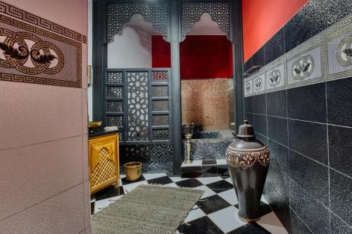 a bathroom with a black and white checkered floor at Kasbah Beldy Chic Marrakech, heated pool, spa in Marrakesh