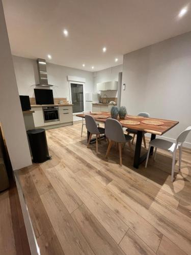 a kitchen and dining room with a wooden table and chairs at Châtelaines 59 in Avallon
