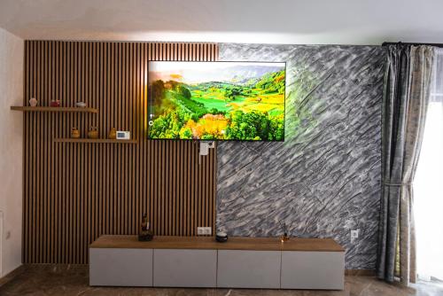 a living room with a painting on the wall at Dey Villa, Valea Avrigului, Transilvania in Avrig