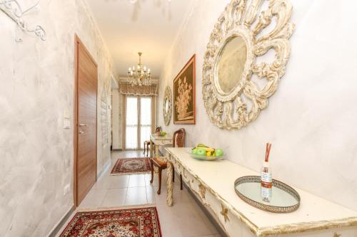 a hallway with a table and a mirror on the wall at Le Bouganville Apartment- Downtown & close to the beach in Desenzano del Garda