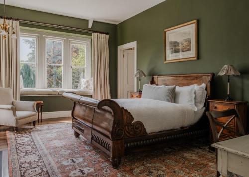 a bedroom with a bed and a chair and a window at The Green in Wingfield