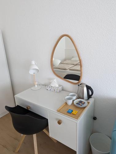 a white desk with a mirror and a chair at HarmoNest 1 Mgladbach South in Mönchengladbach