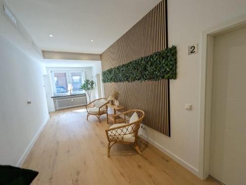 a room with chairs and a table and a wall at HarmoNest 1 Mgladbach South in Mönchengladbach