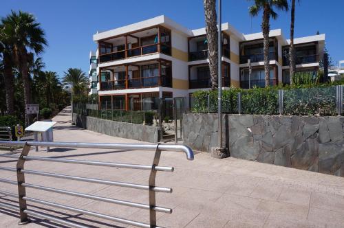 a building with a bench in front of it at Vv - San Agustín Seaview Apartment in San Agustin