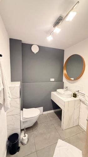 a bathroom with a sink and a toilet and a mirror at Domek 80m2 na wyłączność in Tczew