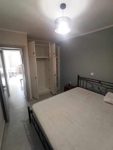 a bedroom with a large bed and a light at Pierres Blanches Center in Mytilene