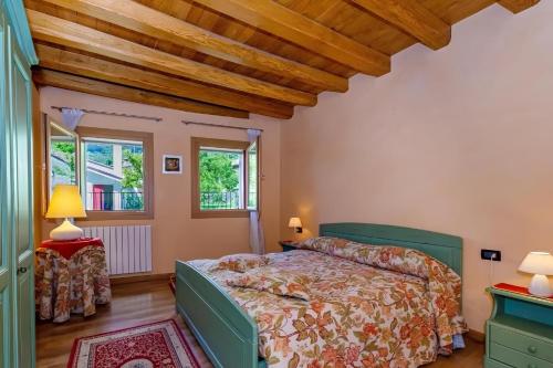 a bedroom with a bed and a wooden ceiling at La Corte di Marga Gustet 5 - Prosecco Hills Holidays in Miane
