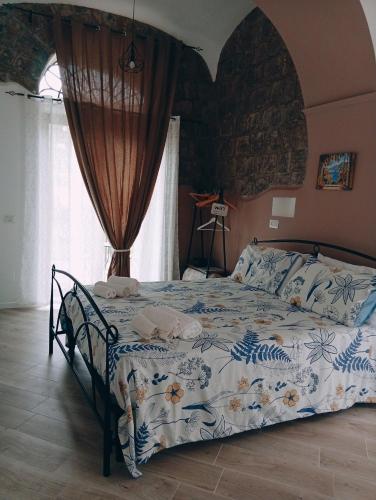 a bedroom with a bed in a room with a window at Il borgo in Vico Equense