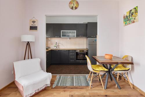 a kitchen with a table and chairs in a room at Maslina Krtoli in Tivat
