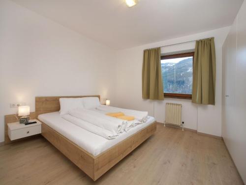 เตียงในห้องที่ Apartments Obernosterer - Großglockner