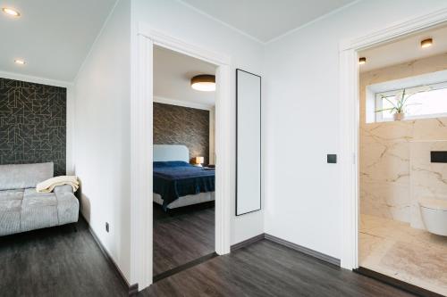 a bedroom with a bed and a couch and a mirror at Sea view apartment Haapsalu in Haapsalu