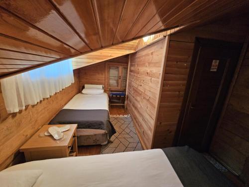 a small room with two beds and a desk at HEVAS Suite in Ayder Yaylasi