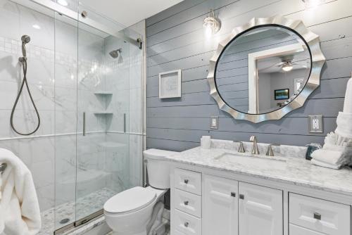a bathroom with a shower toilet and a mirror at Harbour Oaks, Unit 419 in Saint Simons Island