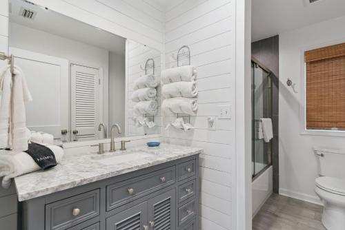a bathroom with a sink and a toilet and a mirror at Harbour Oaks, Unit 413 in Saint Simons Island