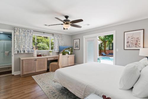 a bedroom with a bed and a desk and a television at Sea Renity - 4333 Twelfth Street in Saint Simons Island