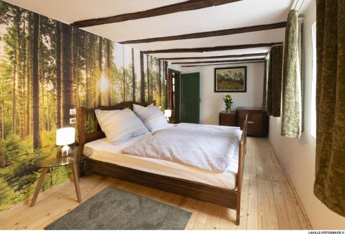 a bedroom with a bed in a room with trees at BeiArnold in Schleiden