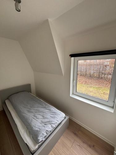 a small bedroom with a bed and a window at High Coast Stay Floor 2 in Ramvik