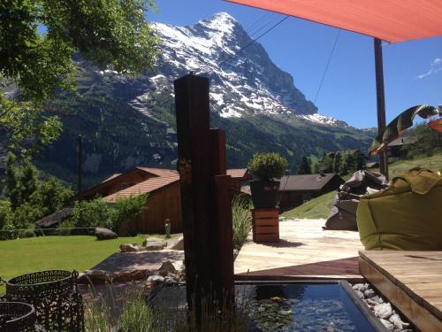 a view of a snow covered mountain from a patio at Hotel Lauberhorn - Home for Outdoor Activities in Grindelwald