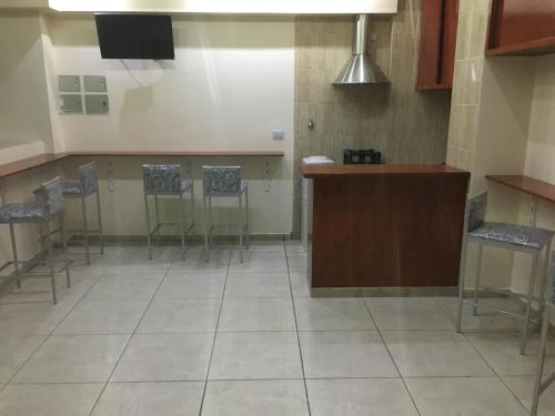 a kitchen with chairs and a counter in a room at Hotel El Porteño in Buenos Aires