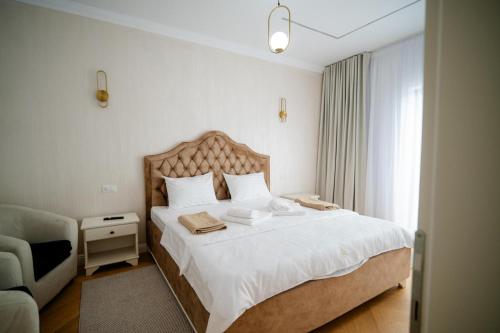 a bedroom with a large bed with white sheets at Leo Resort and Spa in Petrova