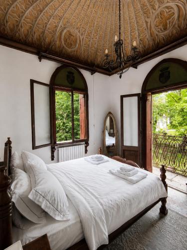a bedroom with a large bed and two windows at Lake House by Veneto Villa in Albignasego