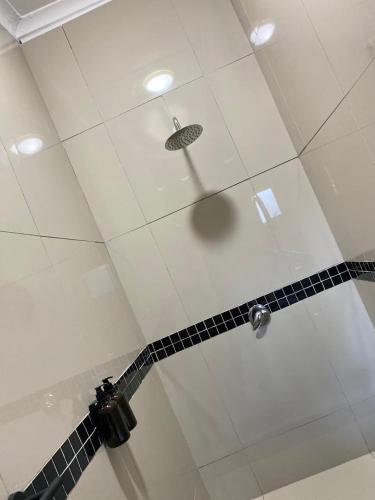 a shower with a shower head in a bathroom at Nvivi boutique hotel in Polokwane