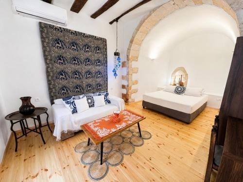 a large room with a bed and a table at Venetian Palace Chania - Adults Only in Chania