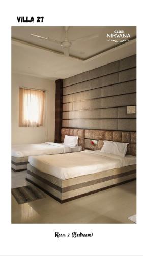 two beds in a hotel room with at Villa 27 in Sonāpur