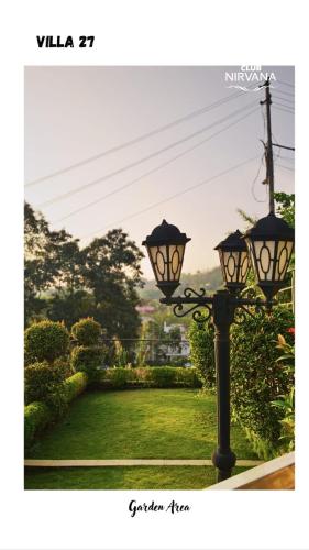a lamp post in a yard with a view at Villa 27 in Sonāpur