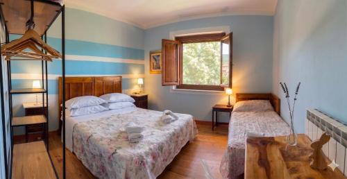 a bedroom with two beds and a window at Bed & Breakfast Le Piagge in Scurcola Marsicana