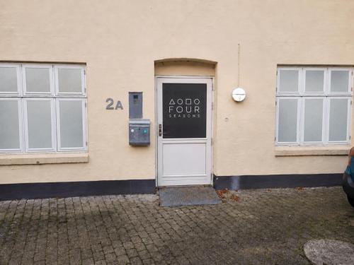 a door of a building with a sign on it at 4SEASONS -- Emerald Summer Lounge in Aalborg