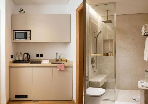 a bathroom with a sink and a toilet and a shower at La Terrasse Hotel in Jeddah